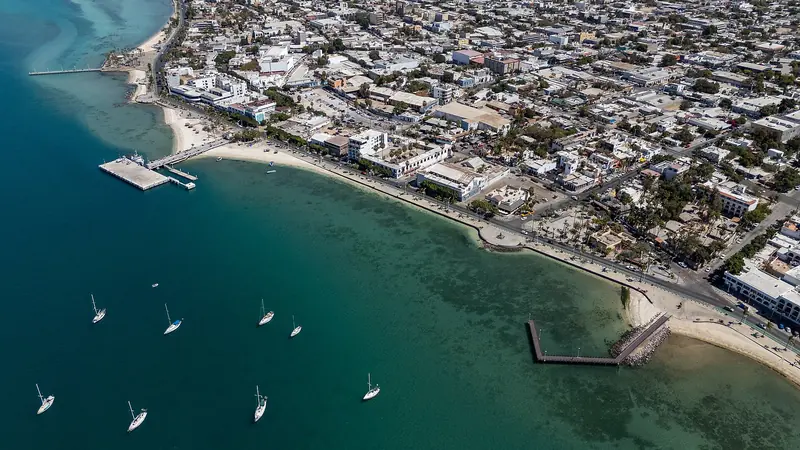 Aerial view of the La Paz waterfront with its pier, the beach and sailboats at anchor
