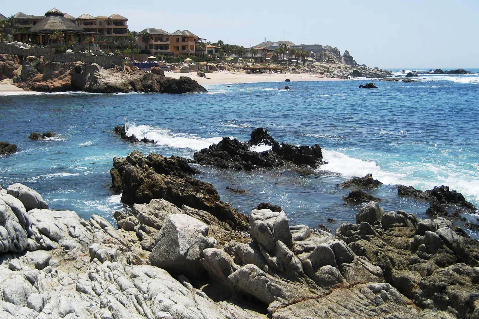 The beach below Esperanza resort at Punta Ballena, with rocks and breaking waves