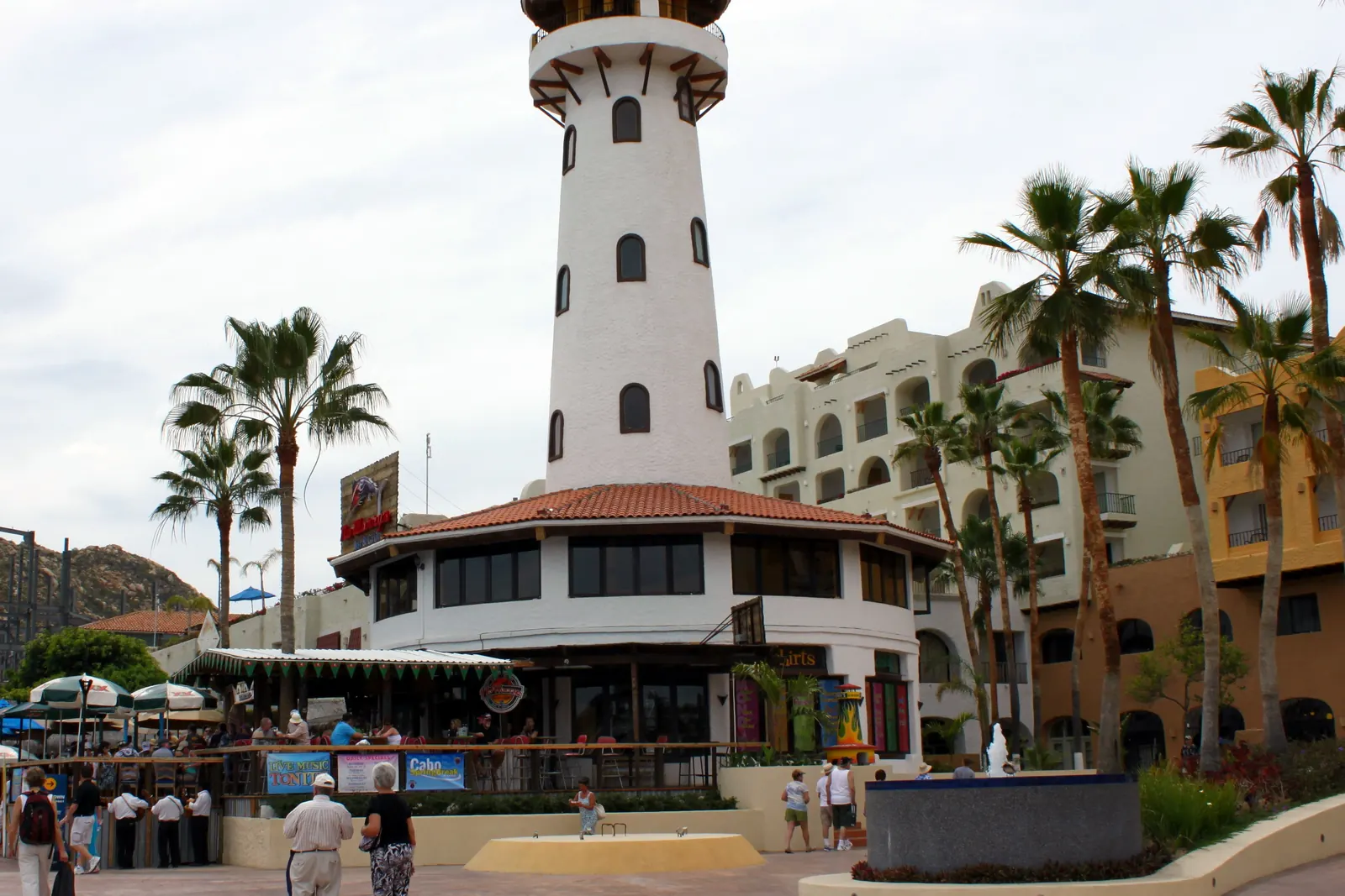 Lighthouse-style tower and hotel buildings on the Cabo San Lucas marina boardwalk