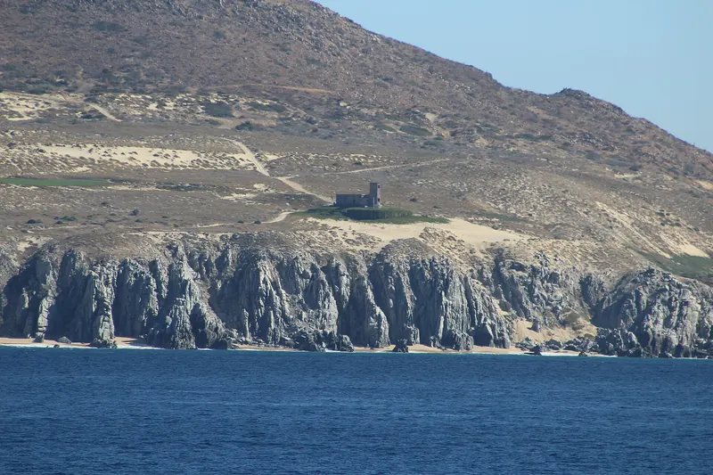 Old Cabo Falso lighthouse on the dunes above the granite cliffs of the Pacific coast