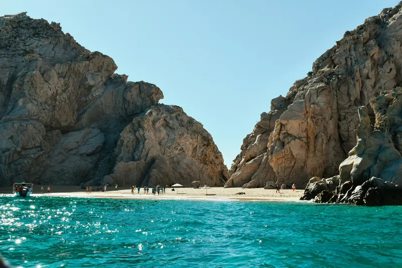 Lover's Beach between granite walls, seen from the water