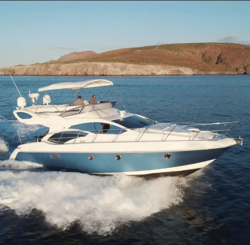 Azimut 45 Flybridge underway off the Baja coast, with two crew at the flybridge helm