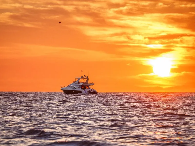 The Azimut 70 on the water at sunset off Cabo San Lucas, the hour most proposals are timed for