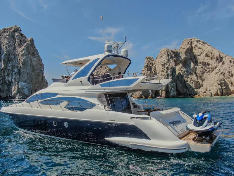 The Azimut 70 flybridge yacht at the Arch with the granite rocks of Land's End behind it