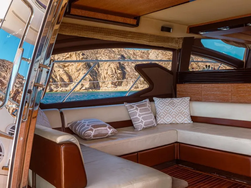 Azimut 70 salon with U-shaped sofa and windows onto the bay