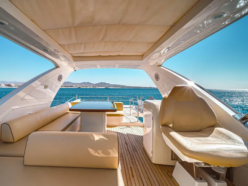 Azimut 70 flybridge with table and bench seating under the hardtop