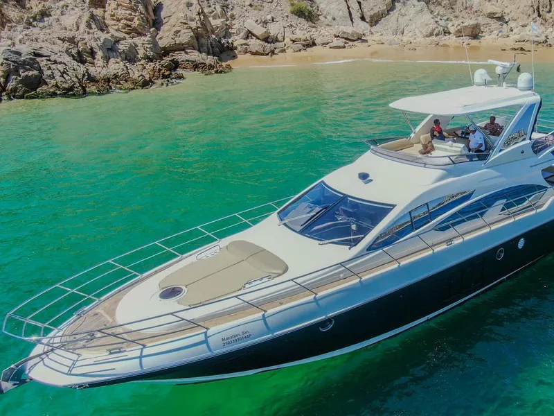 Azimut 70 anchored over turquoise water off a beach