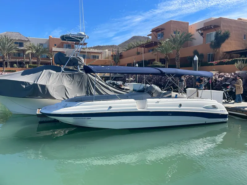 The Chaparral 28 sport boat with a navy bimini top tied up at Marina Cabo San Lucas