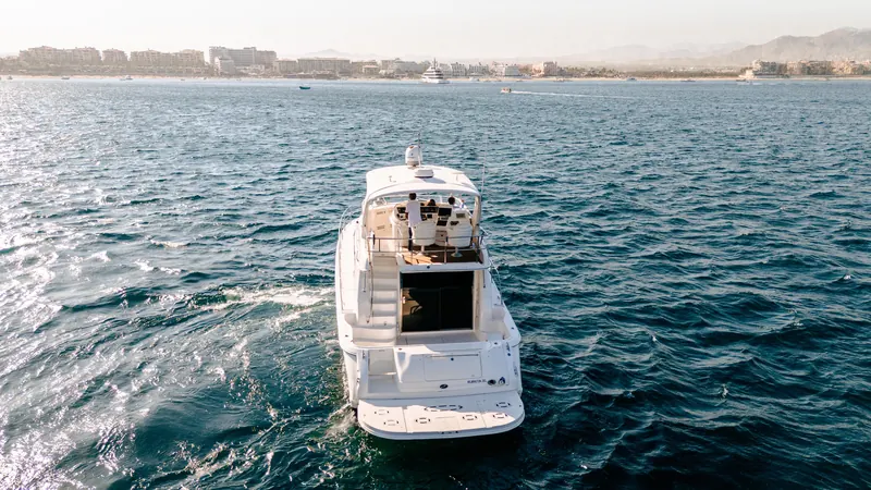 The Sea Ray 55 flybridge yacht heading back across the bay toward the hotels of Cabo San Lucas